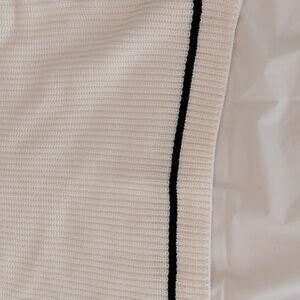 Casual knitted white sanctuary sweater with blue trim.